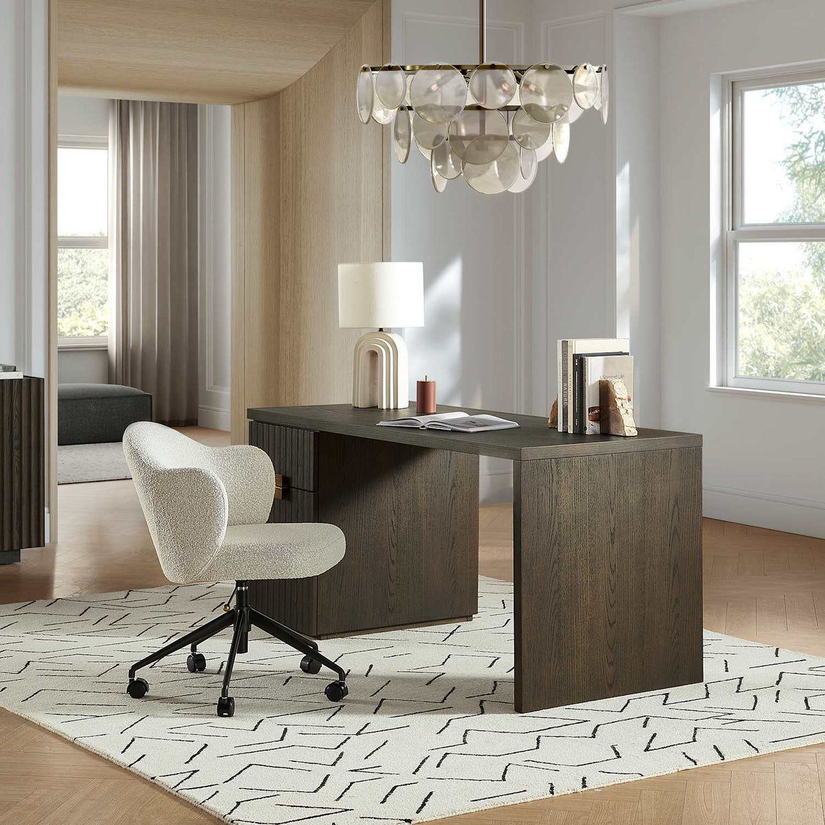 Simone white boucle office chair at a dark wood desk