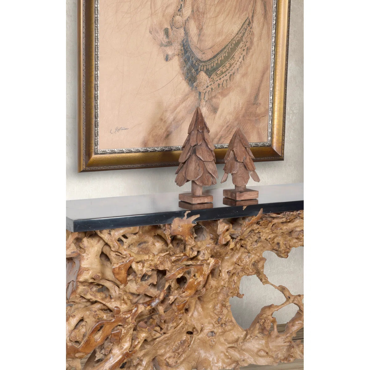 Andrek teak wood trees on a console under a framed print