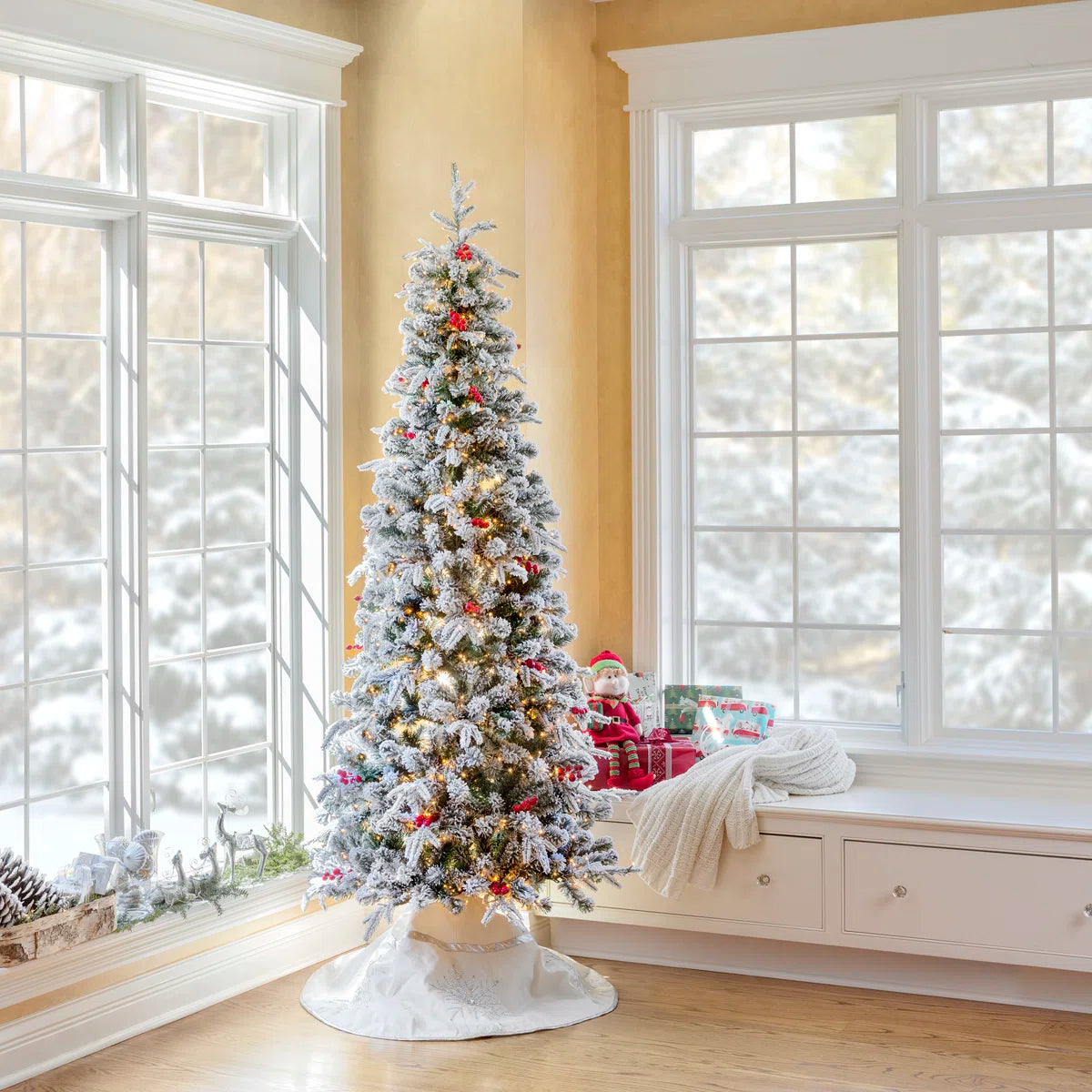 Lexington slim frosted tree by a snowy window