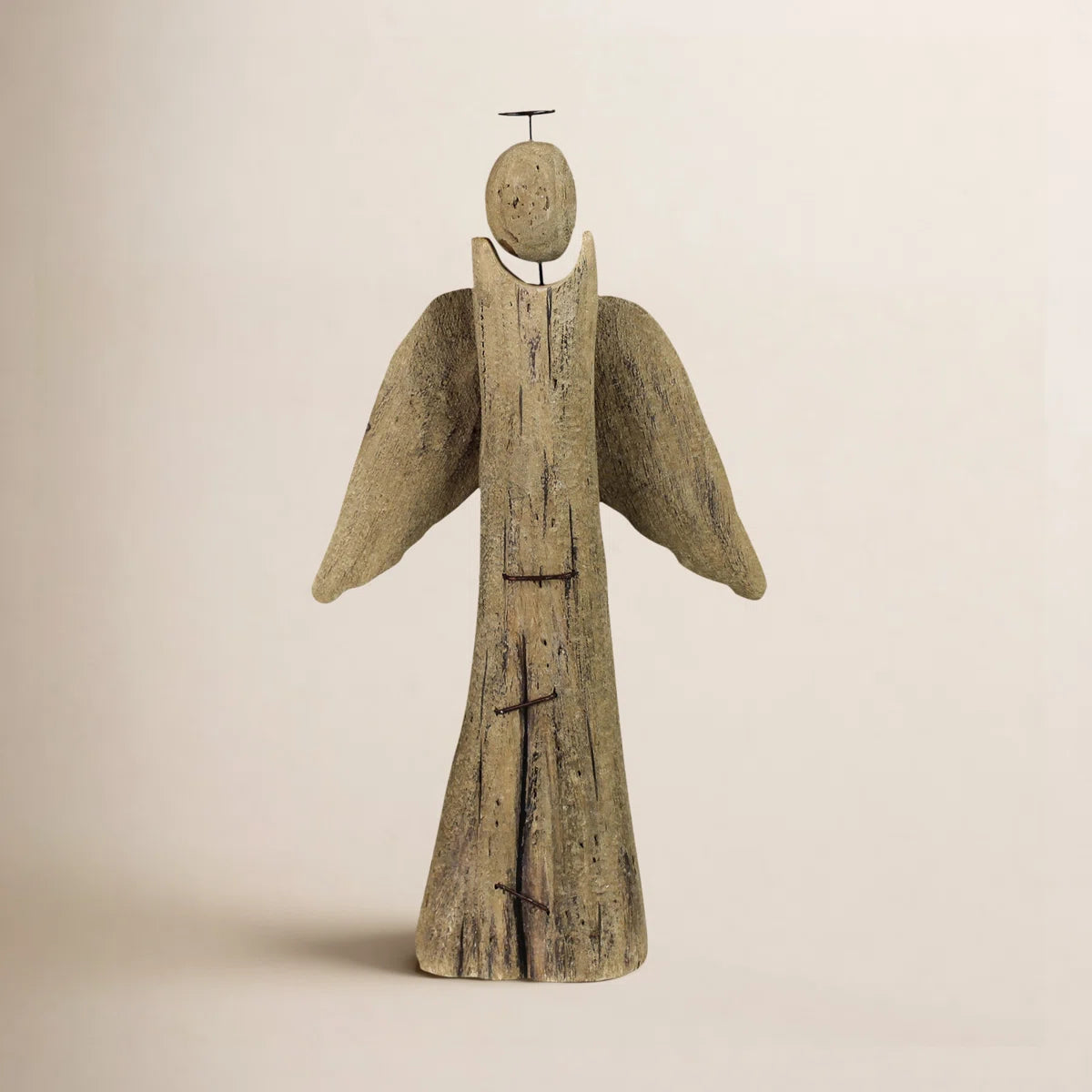 Rustic wood angel on a warm beige background