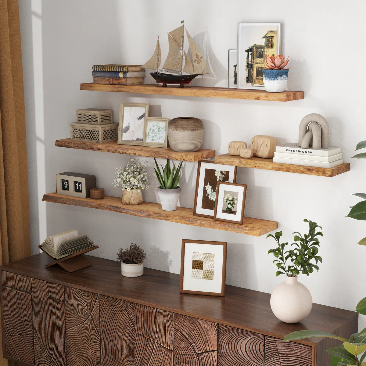 Carsin live edge elm floating shelves styled with books and frames in a living room