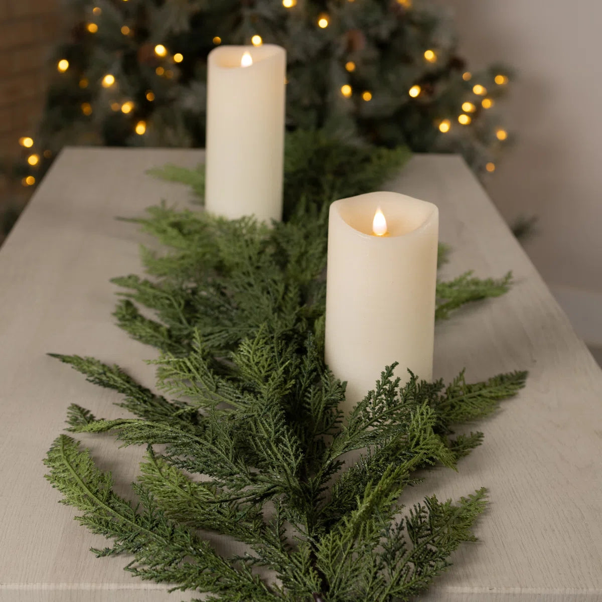 Cedar garland on a table with white candles