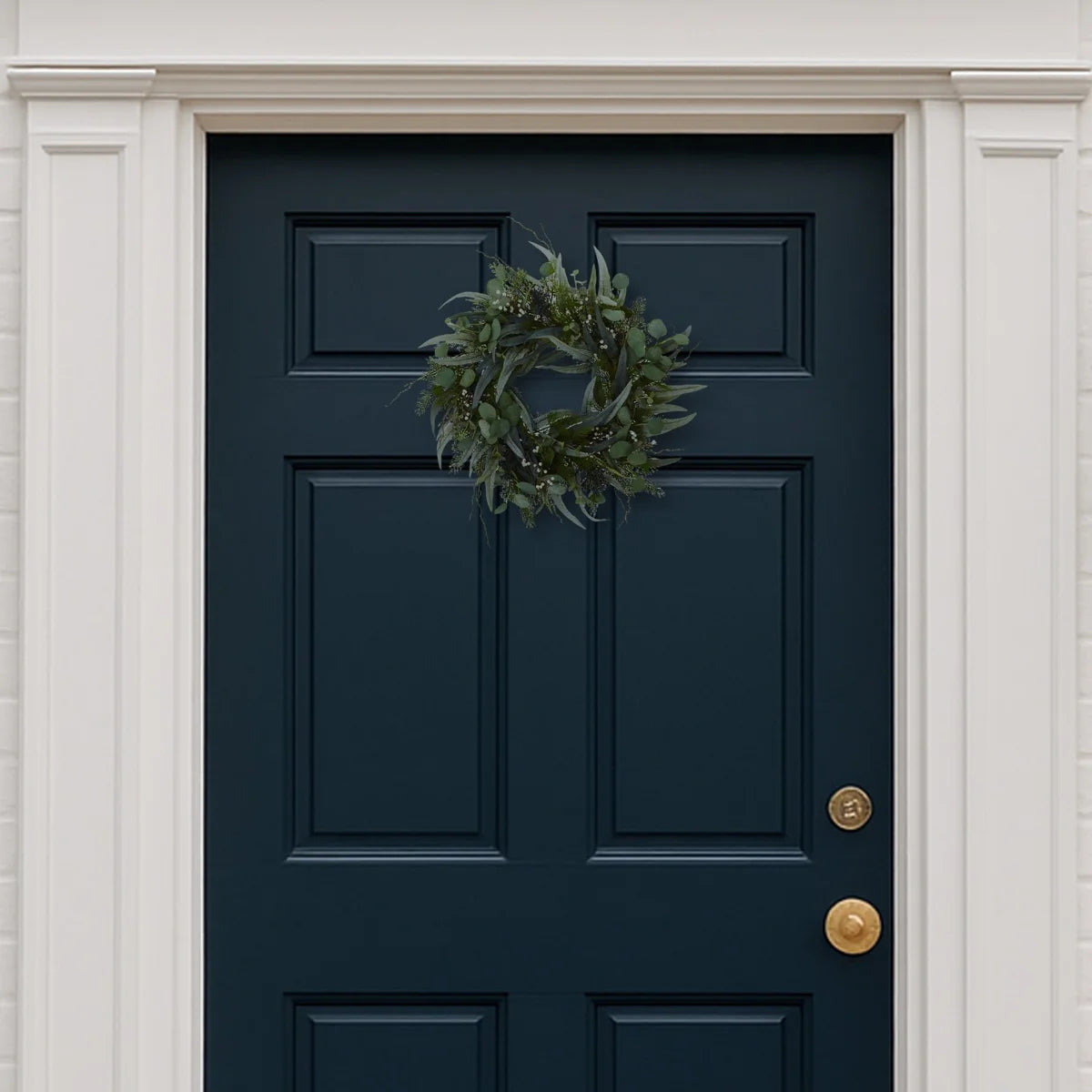 Eucalyptus wreath on a dark blue front door