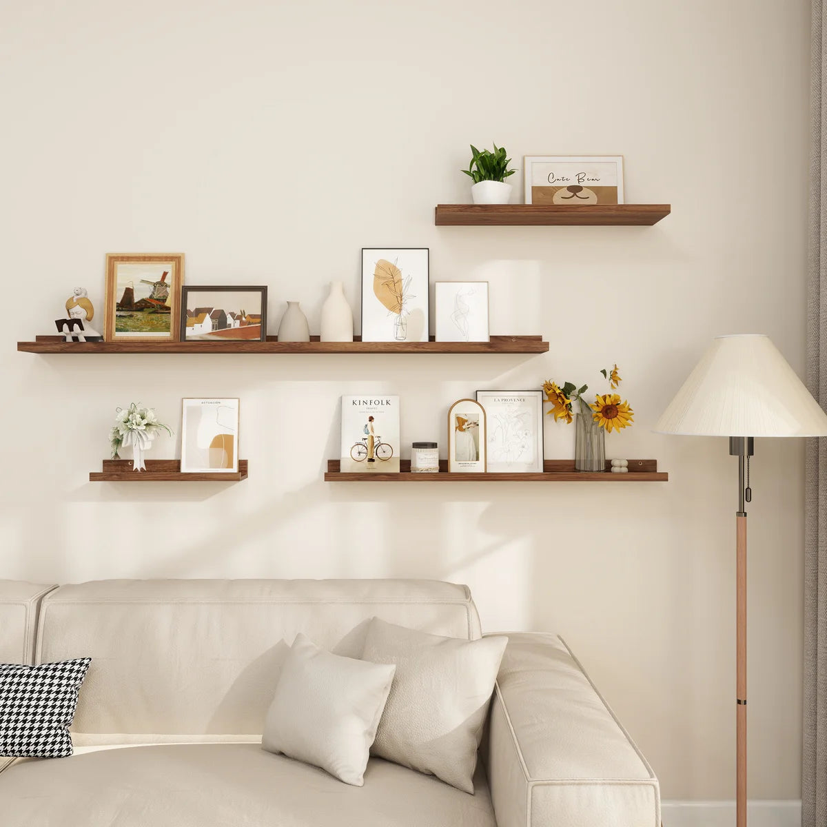 Parece walnut picture ledges with frames above a sofa