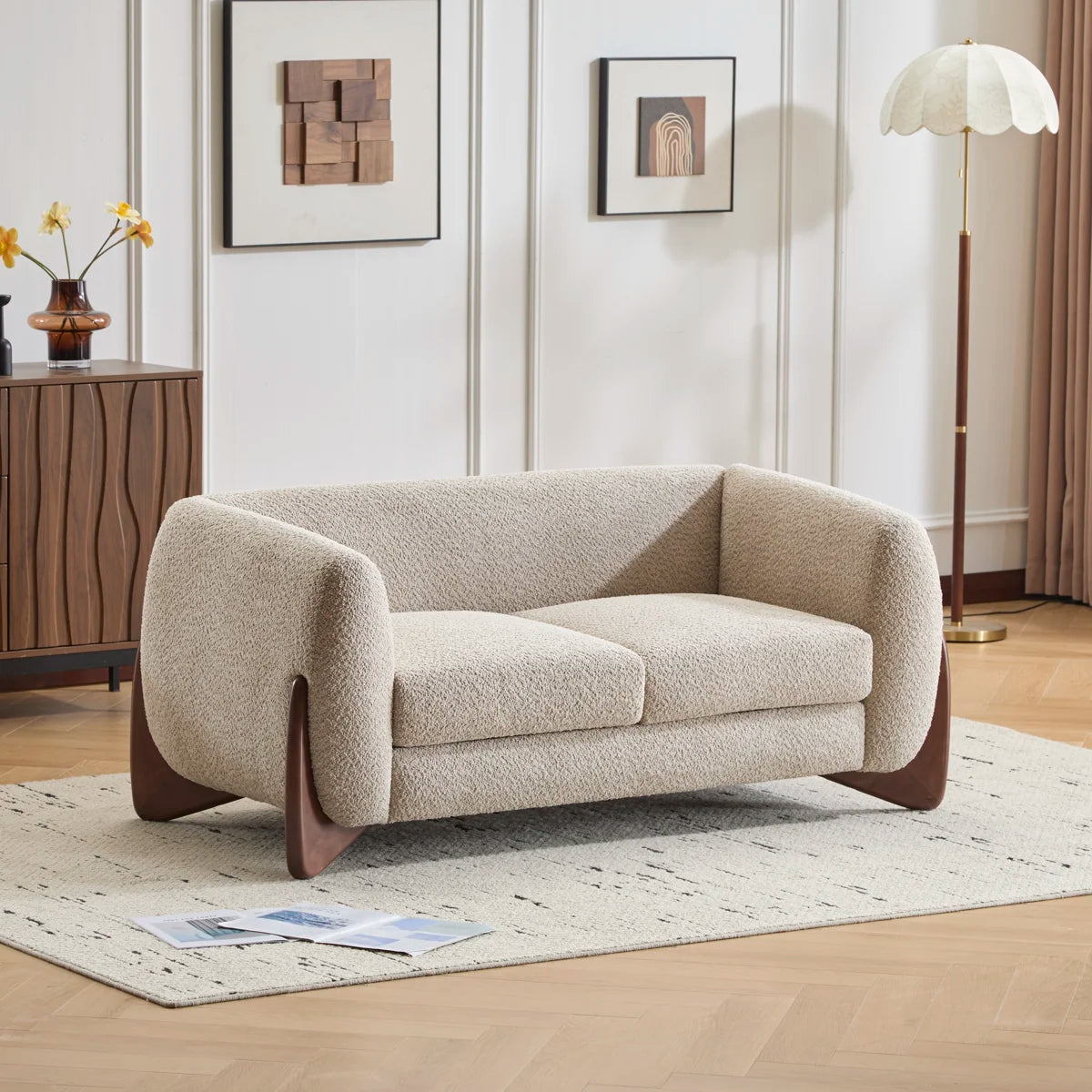 Japandi boucle loveseat Rhudine in almond with walnut-tone legs in a living room