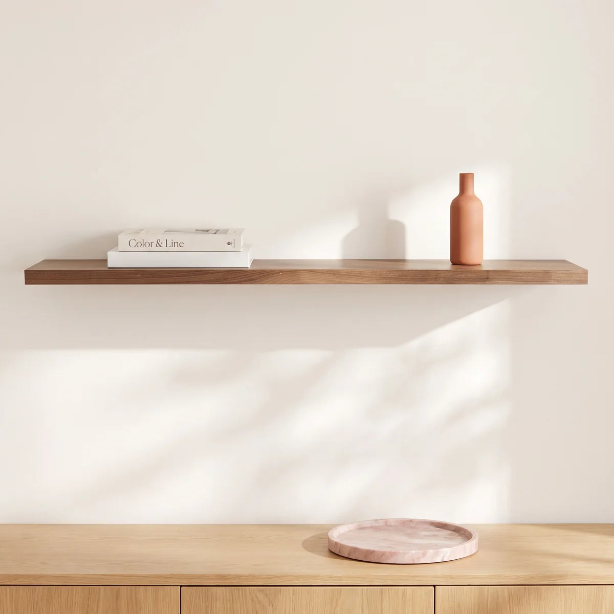 Sherice long walnut floating shelf on a warm white wall