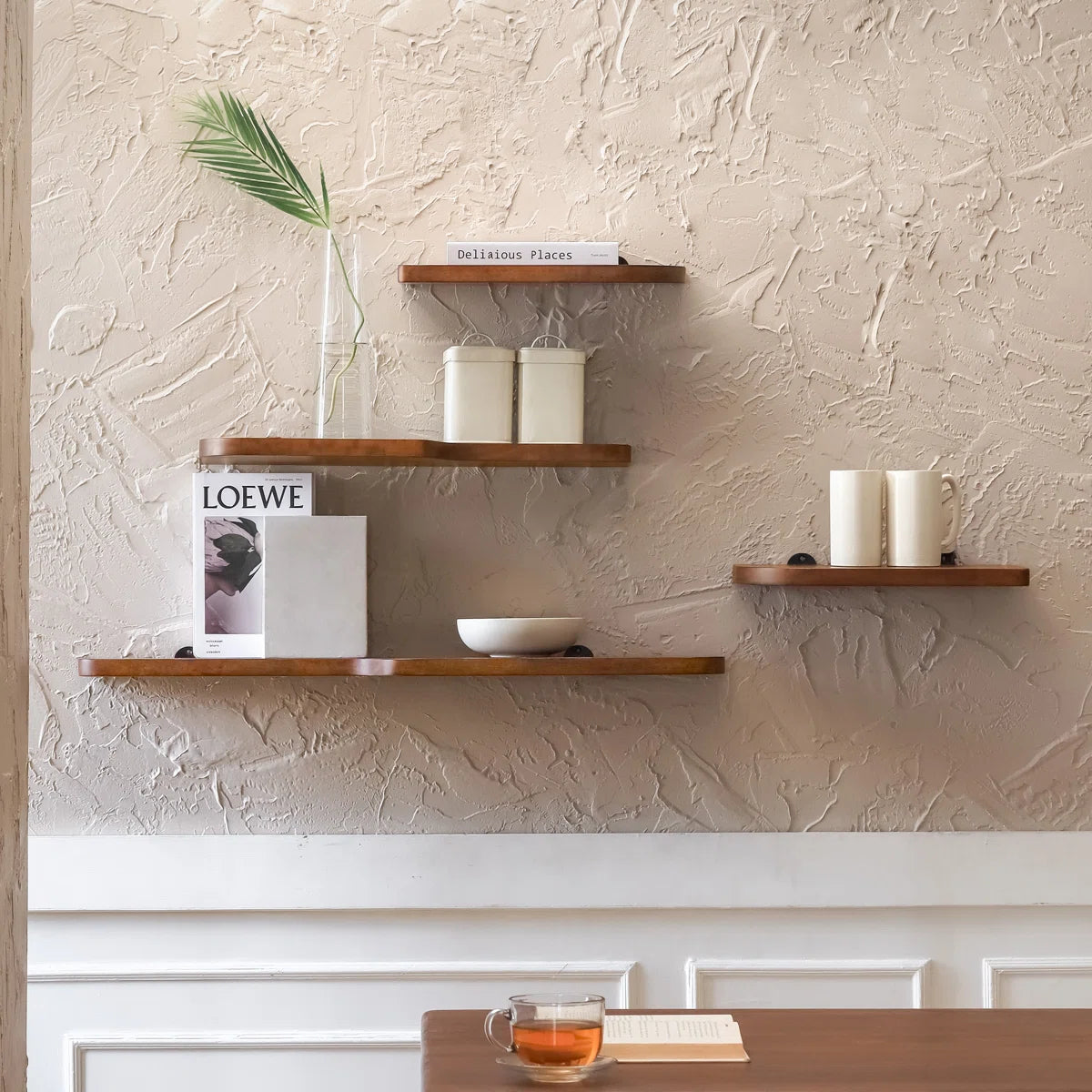 Valetta walnut display shelves arranged on a textured wall