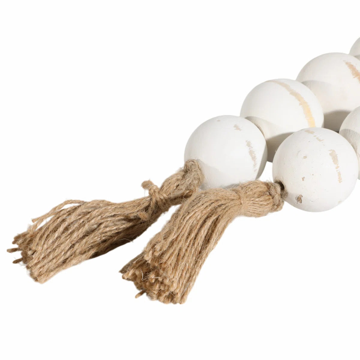 White wood beads and jute tassels close-up